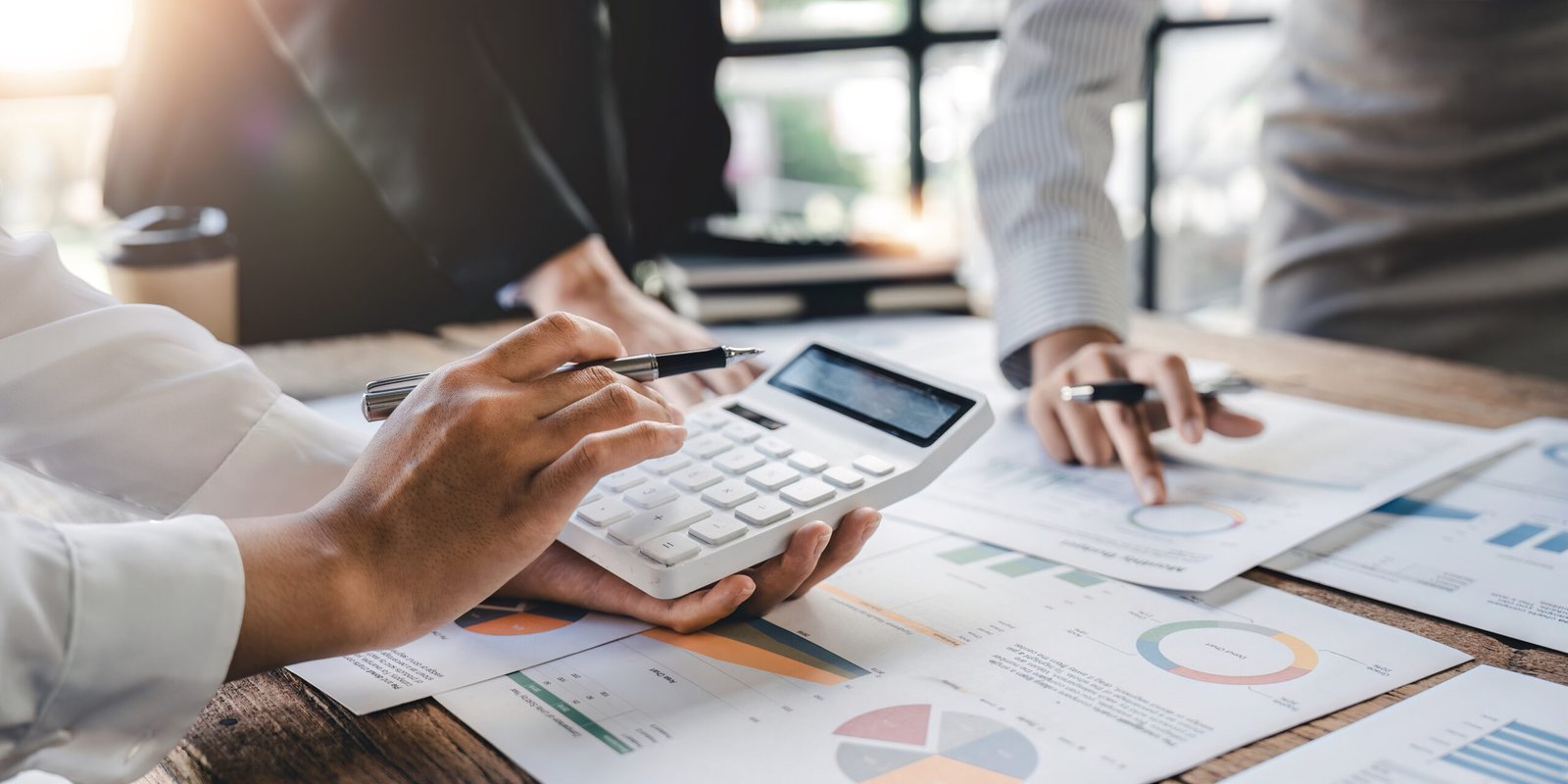 Businesswoman or accountant working Financial investment on calculator, calculate, analyze business and marketing growth on financial document data graph, Accounting, Economic, commercial concept Businesswoman or accountant working Financial investment on calculator, calculate, analyze business and marketing growth on financial document data graph, Accounting, Economic, commercial concept.